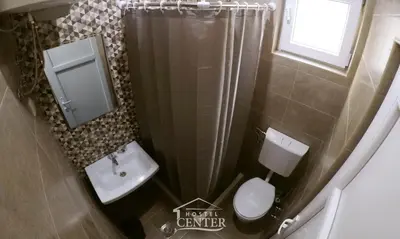 a small bathroom with a toilet and a sink at Hostel Center in Ulcinj