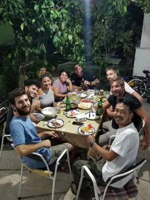a group of people sitting around a table eating at Hostel Center in Ulcinj