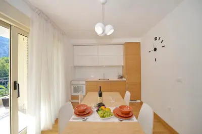 a kitchen with a table with a bowl of fruit on it at Posto Capitano C Group in Kotor