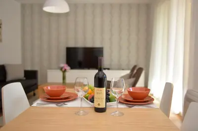 a bottle of wine sitting on a table with two glasses at Posto Capitano C Group in Kotor