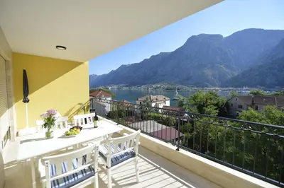 a balcony with a view of a lake and mountains at Posto Capitano C Group in Kotor