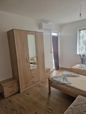 a bedroom with a large wooden cabinet and a bed at Apartmani Sijaric in Dobra Voda