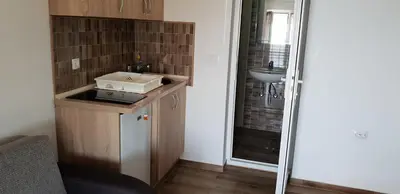 a small bathroom with a sink and a shower at Apartmani Sijaric in Dobra Voda