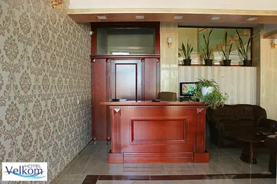 a wooden podium in a lobby with a couch at Hotel Velkom in Sutomore