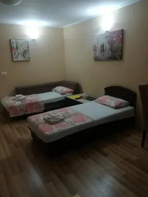 a room with two beds and a table at Apartments Vis Jaz in Budva