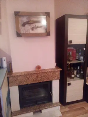 a fireplace in a living room with a mantle at Apartments Vis Jaz in Budva