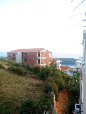 a building on the side of a hill at Apartments Vis Jaz in Budva