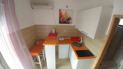 a small kitchen with a counter and a sink at Apartman Bećir in Budva