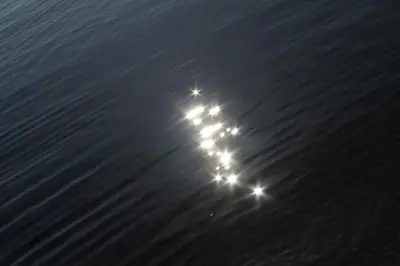 a flash of lights in the water at night at Apartman Bećir in Budva