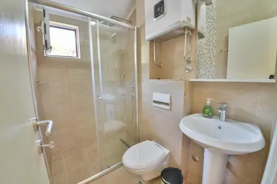 a bathroom with a shower and a toilet and a sink at Apartmani Raskovic in Budva