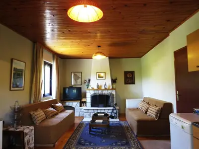 a living room with two couches and a tv at Estate & Winery San Duyevo in Rijeka Crnojevića