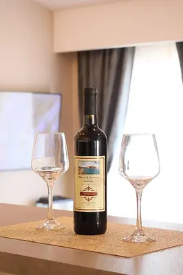 a bottle of wine and two wine glasses on a table at Apartment Mitrovic in Budva