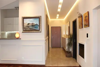 a hallway with white walls and a painting on the wall at Apartment Mitrovic in Budva