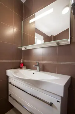 a bathroom with a white sink and a mirror at Apartment Mitrovic in Budva