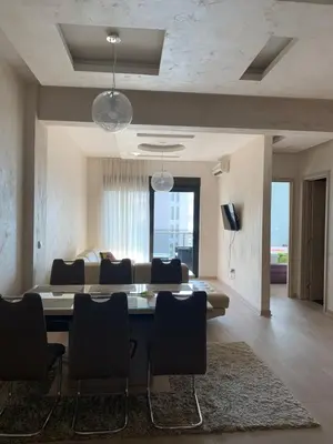 a living room with a dining table and a couch at Apartment Seaview Budva in Budva