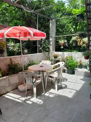 a table and chairs and an umbrella on a patio at Apartment Radovic in Kotor