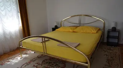 a yellow bed with a metal frame in a bedroom at Borgo Del Silenzio,Apartment With Pool in Bar