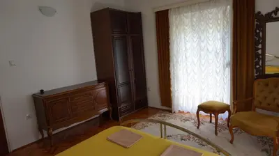a bedroom with a bed and a chair and a dresser at Borgo Del Silenzio,Apartment With Pool in Bar