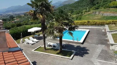 an aerial view of a resort with a pool and palm trees at Borgo Del Silenzio,Apartment With Pool in Bar