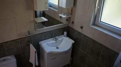 a bathroom with a sink and a mirror and a toilet at Borgo Del Silenzio,Apartment With Pool in Bar