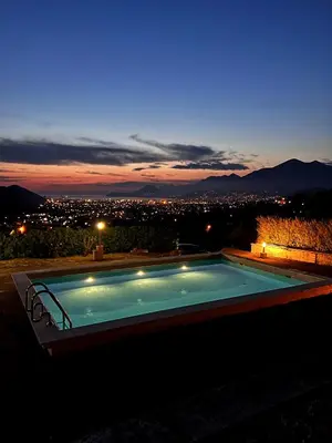 a swimming pool at night with a view of a city at Borgo Del Silenzio,Apartment With Pool in Bar