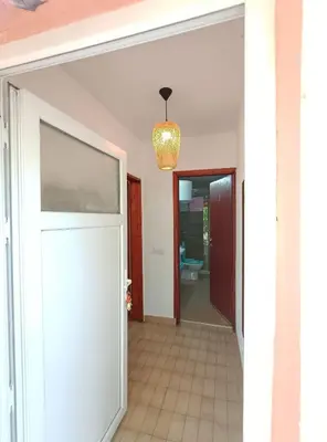 a hallway with a white door and a chandelier at President Holiday home in Utjeha