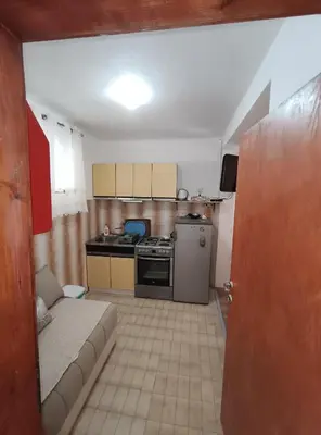 a small kitchen with a couch in a room at President Holiday home in Utjeha