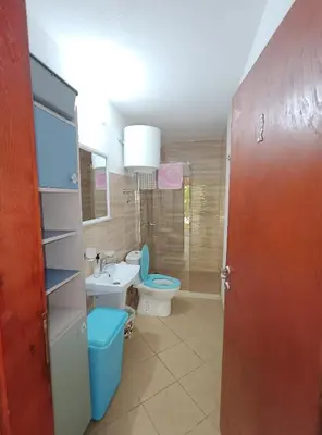 a bathroom with a toilet and a sink at President Holiday home in Utjeha