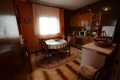 a kitchen with a table and chairs and a window at President Holiday home in Utjeha