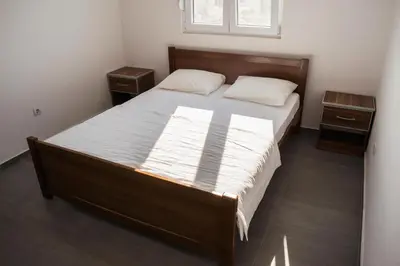 a bedroom with a large bed with two night stands at Apartments Leyla in Ulcinj
