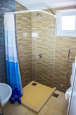 a bathroom with a shower with a toilet and a sink at Apartments Leyla in Ulcinj