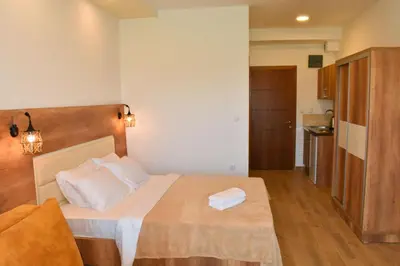 a small bedroom with a bed and a kitchen at Beach Walk Apartments in Ulcinj