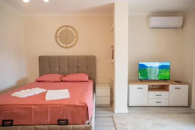 a bedroom with a bed and a flat screen tv at Beach Walk Apartments in Ulcinj