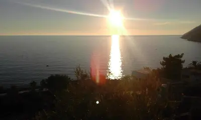 a view of the ocean at sunset from aominium at Apartman Marinkovic in Dobra Voda