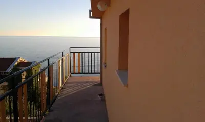 a view of the ocean from a balcony at Apartman Marinkovic in Dobra Voda