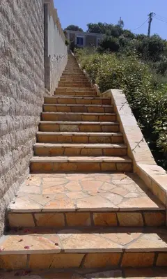 a set of stairs next to a brick wall at Apartman Marinkovic in Dobra Voda