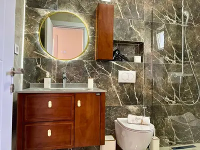 a bathroom with a sink and a toilet and a mirror at Apartments Gazi in Ulcinj