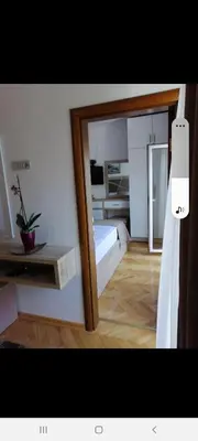 a mirror in a room with a bed and a bedroom at Apartments Gazi in Ulcinj
