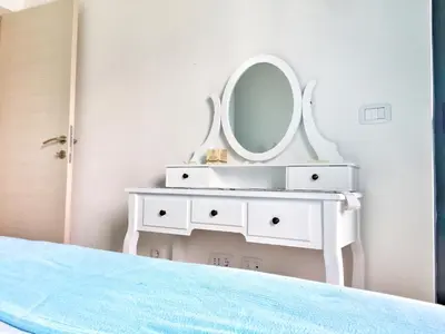 a white dressing table with a mirror on it at Apartment Divina in Sveti Stefan