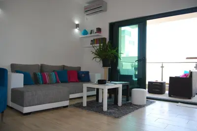 a living room with a couch and a table at Apartment Divina in Sveti Stefan