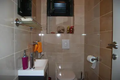 a bathroom with a toilet and a sink at Apartment Divina in Sveti Stefan