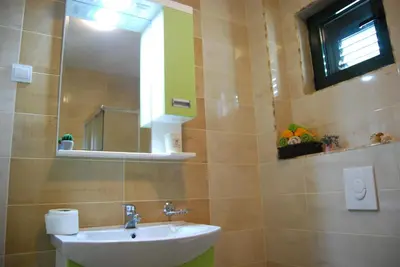 a bathroom with a sink and a mirror at Apartment Divina in Sveti Stefan