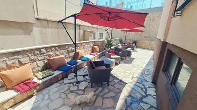a red umbrella sitting on top of a patio at Apartments Kaladjurdjevic in Budva