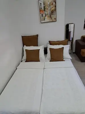 a large white bed in a white room at Apartments Kaladjurdjevic in Budva