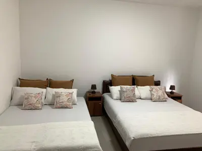 two beds sitting next to each other in a room at Apartments Kaladjurdjevic in Budva