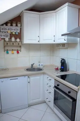a kitchen with white cabinets and a sink at Apartment Dadi in Cetinje