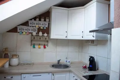 a kitchen with white cabinets and a sink at Apartment Dadi in Cetinje