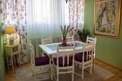 a dining room with a white table and chairs at Apartment Dadi in Cetinje