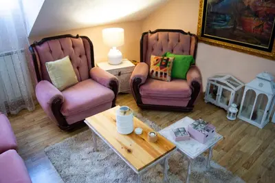 a living room with two chairs and a coffee table at Apartment Dadi in Cetinje