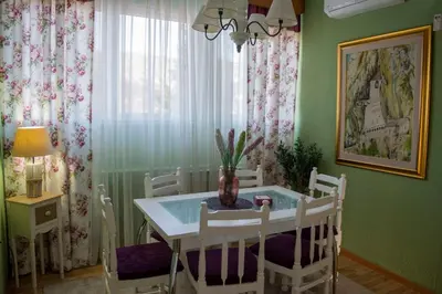 a dining room with a table and white chairs at Apartment Dadi in Cetinje